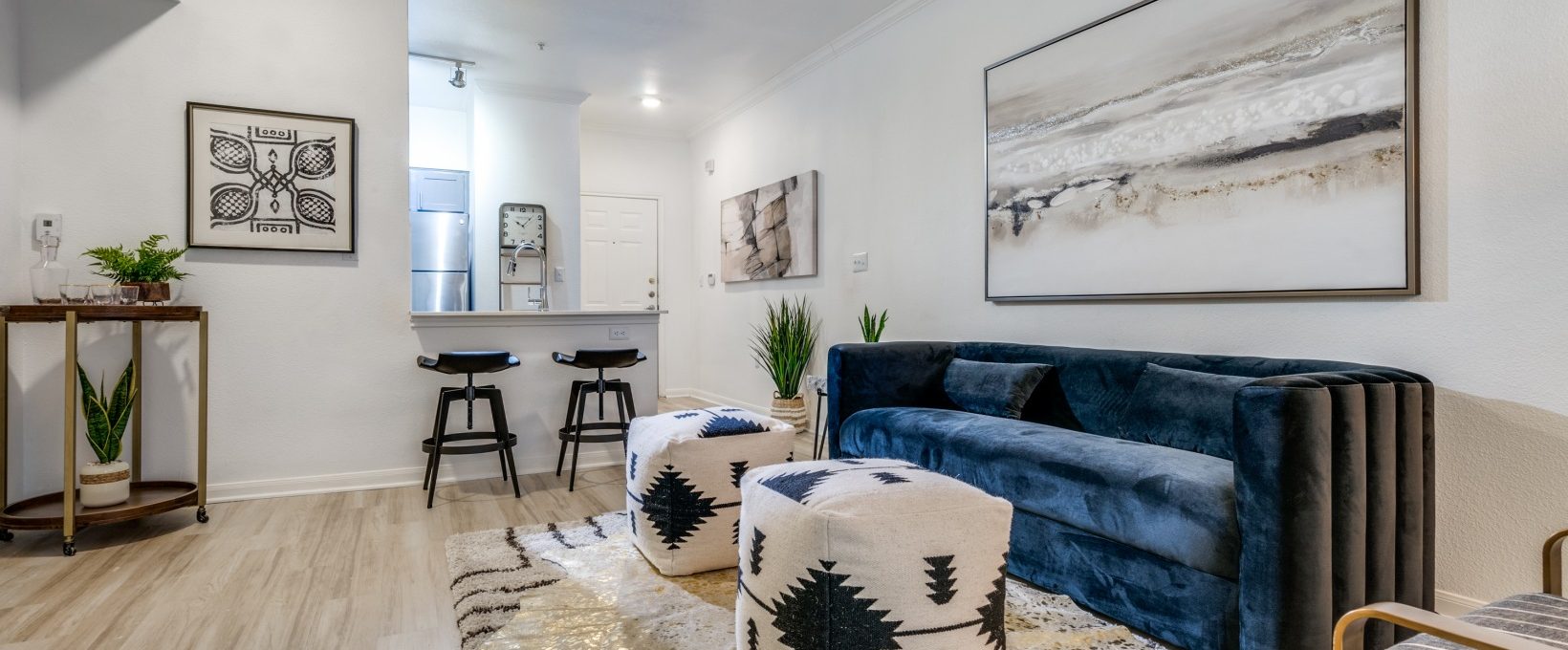 a living room with a couch, coffee table and rug at The NEO Midtown