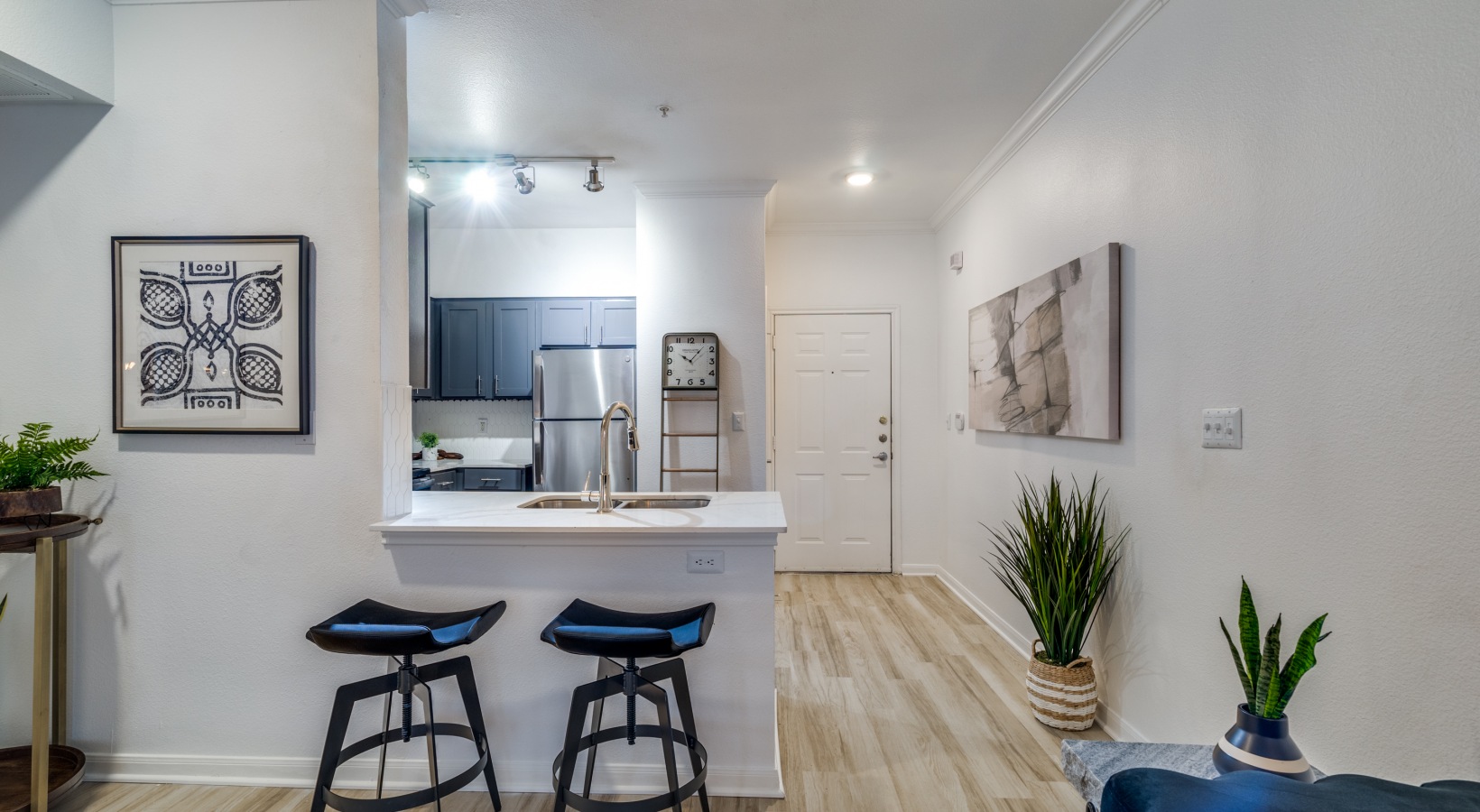 a kitchen with a bar and a dining area at The NEO Midtown